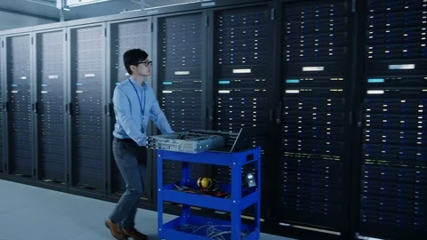 In the Modern Data Center: IT Engineer Doing Maintenance and Diagnostics. Stock Footage 101180913