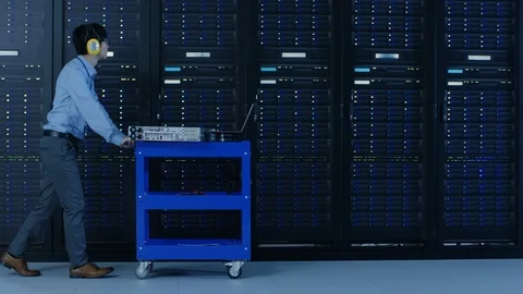 In the Modern Data Center: IT Engineer Doing Maintenance and Diagnostics. 動画素材 101184981