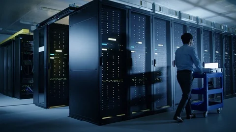 In the Modern Data Center: IT Engineer Doing Maintenance and Diagnostics. 動画素材 101187874