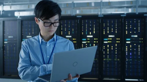 In the Modern Data Center: Portrait of IT Engineer Standing with Server Racks Stock Footage 101181921