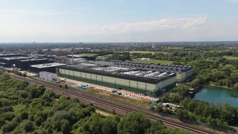 Modern Data Centre Campus With Railway Tracks and Lake During the Day Stock Footage 339645357