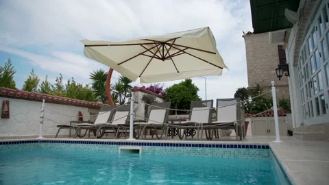 Modern deck chairs near the pool Stock Footage 133562228