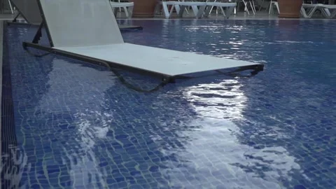 Modern deck chairs near the pool Stock Footage 133563606