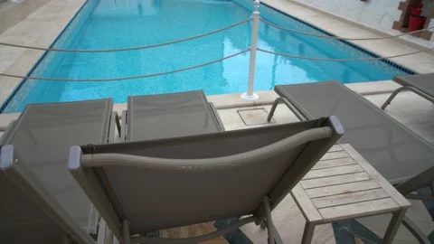Modern deck chairs near the pool 스톡 동영상 133564314