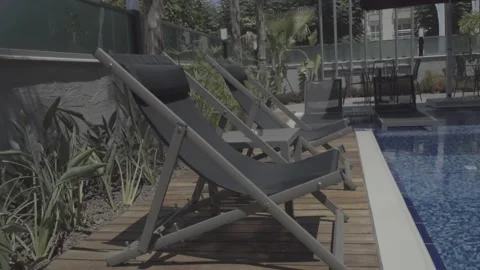 Modern deck chairs near the pool 스톡 동영상 133773649