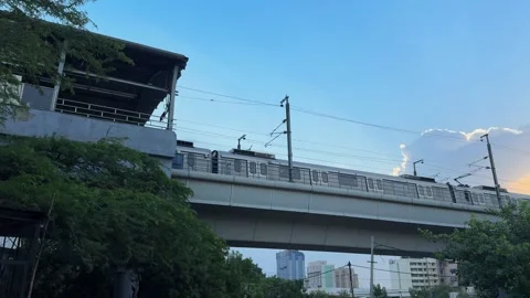 Modern Delhi Metro Train Crossing Elevated Railway Bridge Against Blue Sky .. Stock Footage 337908452