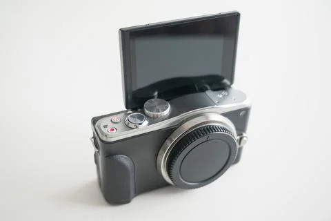 A modern-design mirrorless digital camera with a tilting screen in selfie mod Stock Photos