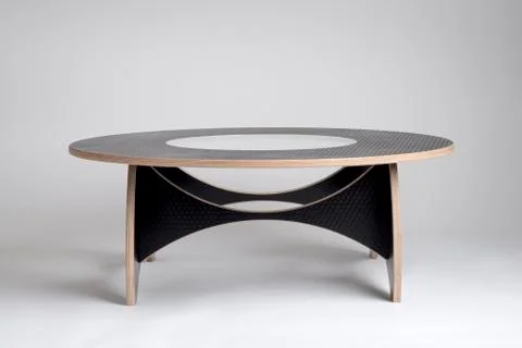 Modern Designer Round Table in Black Honeycomb-Patterned Vinyl Covering Stock Photos