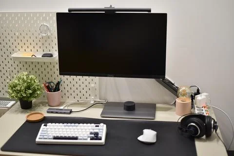 Modern desk setup clean organized with computer monitor keyboard mouse against Foto stock