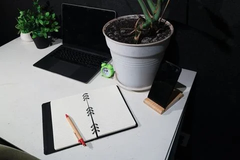 Modern desk setup with laptop, notebook, and smartphone for productive work Stock Photos