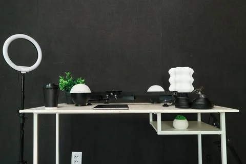 Modern desk setup with ring light, tablet, and creative lighting elements Stock Photos