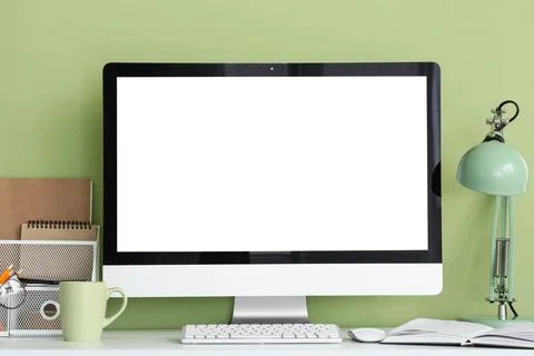 Modern desktop computer with blank white screen on a clean white desk against Stock Photos