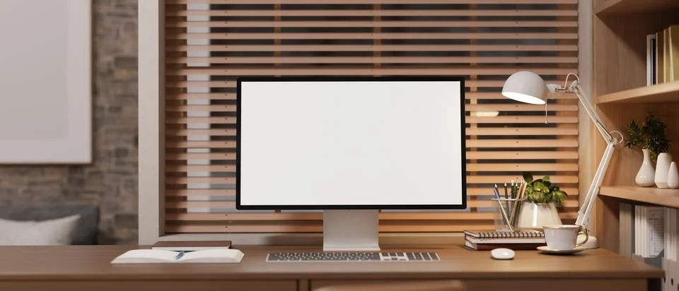 Modern desktop computer mockup on stylish office desk with bookshelf. Illustrazione stock