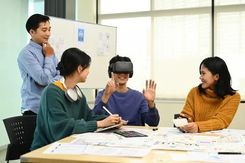 Modern developers team brainstorming, testing virtual reality simulator glasses Stock Photos