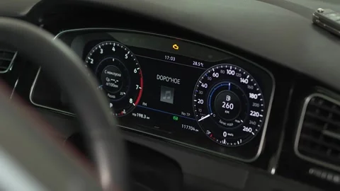 A modern digital car dashboard displaying illuminated gauges and indicators. Stock Footage 342263623
