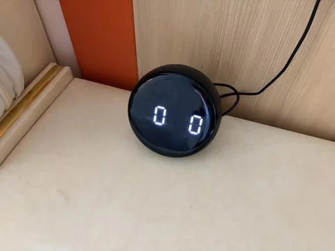 Modern digital clock on a wooden surface. Foto stock
