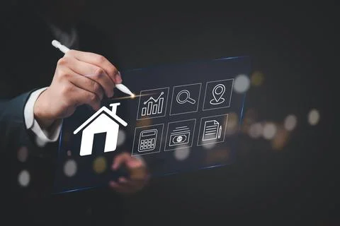 Modern digital interface showing real estate elements with businessman hand.. Stock Photos