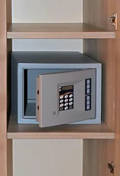 Modern digital pass code empty safe with open door on shelf in a hotel Stock Photos