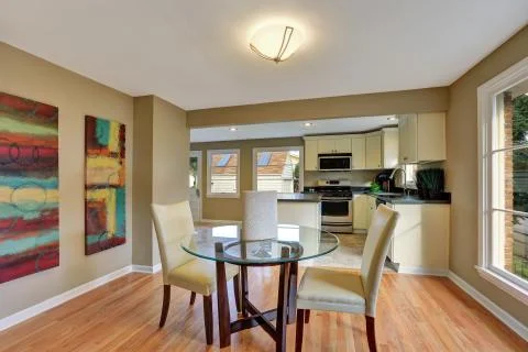 Modern dining area with glass table. Hardwood floor. Northwest, USA Stock Photos