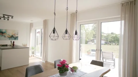Modern Dining Area with Pendant Lights and Garden View, New Home, Wide Shot Stock Footage 341568193