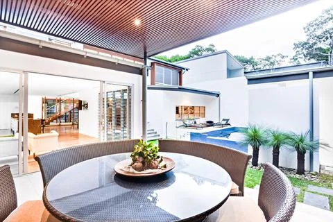 Modern dining table close up including round glass surface Stock Photos