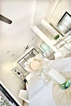 Modern dining table interior with white walls in the kitchen Stock Photos