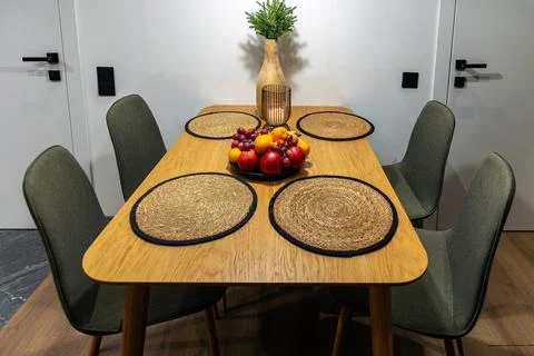 Modern dining table set with fruit centerpiece. A wooden dining table set for Stock Photos