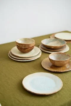 Modern dining table setting. Only natural materials - earthenware, linen Stock Photos