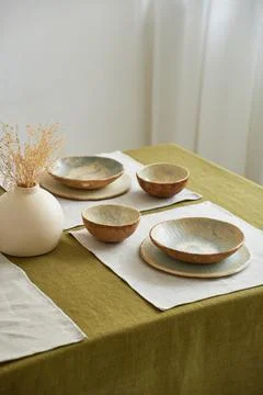 Modern dining table setting. Only natural materials - earthenware, linen Stock Photos