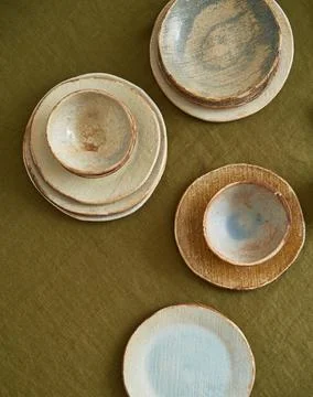 Modern dining table setting. Only natural materials - earthenware, linen Stock Photos