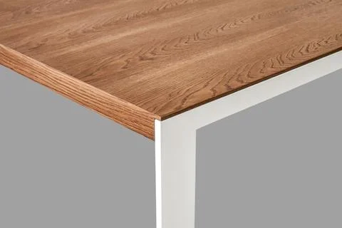 Modern dining table with thin wooden table top with white metal legs Stock Photos