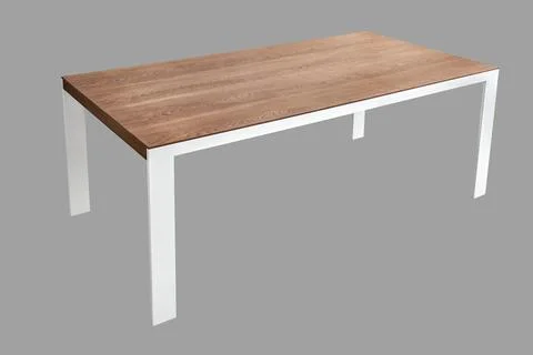 Modern dining table with thin wooden table top with white metal legs Stock Photos