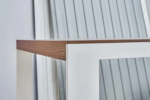 Modern dining table with thin wooden table top with white metal legs Stock Photos