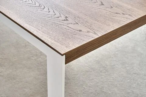 Modern dining table with thin wooden table top with white metal legs Foto stock
