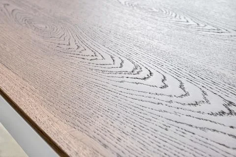 Modern dining table with thin wooden table top with white metal legs Stock Photos