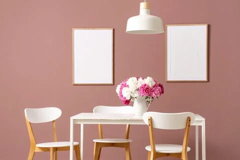 Modern dining table with white chairs and flower vase Stock Photos