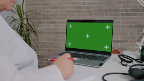 Modern doctor using technology green screen laptop to advance in job degree. Stock Footage 295879312