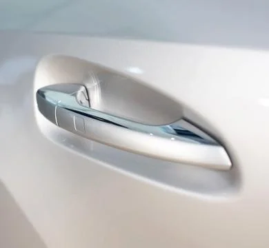 Modern door handle in a car with a button. Keyless Entry System Photos