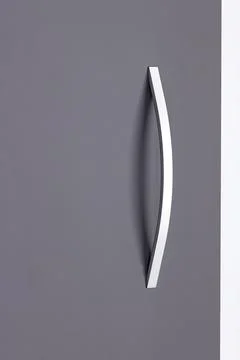 Modern door handle on a gray surface in a well-lit room during daytime with.. Photos