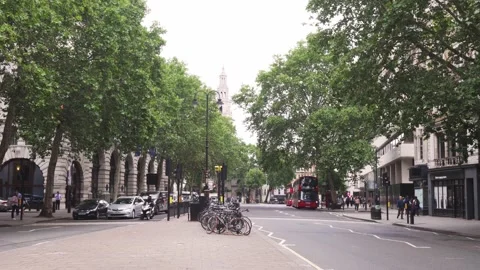 Modern double decker bus driving in street of London city, static wide Stock Footage 142345365