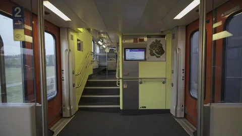 Modern double-decker Swiss train interior with stairs leading to upper level Stock Footage 316626331