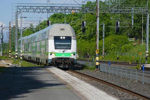 Modern double-Decker train coming of the railway station. Hameenlinna Stock Photos