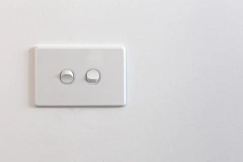 Modern double light switch on white wall with copy space Stock Photos