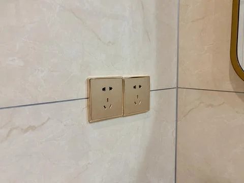 Modern Double Wall Power Outlets in a Tiled Bathroom Stock Photos