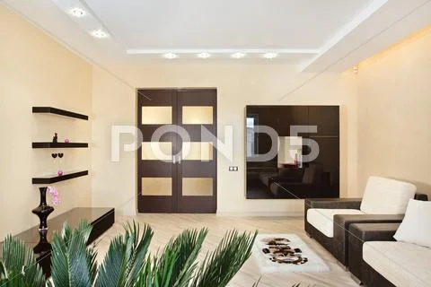 Modern drawing-room interior in warm tones Stock Photos