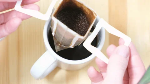 Modern drip coffee bag. The final stage of cooking, removing the drip bag from t Stock Footage 169229000