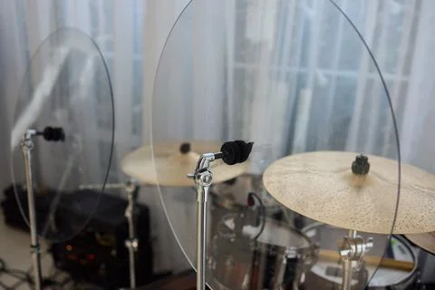 A Modern Drum Set with Acoustic Shields is proudly displayed in a Cozy Studio Stock Photos