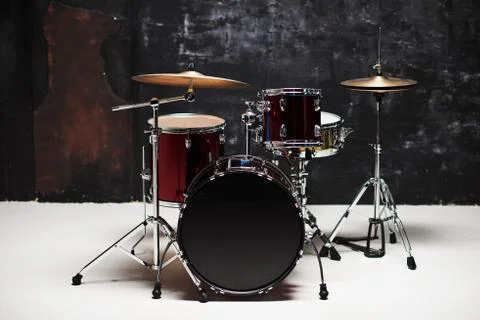 Modern drum set on black background in room Stock Photos