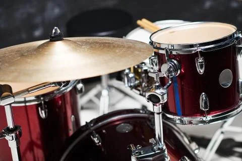 Modern drum set on black background in room Stock Photos