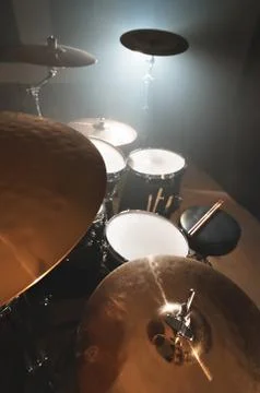 Modern drum set prepared for playing in a dark rehearsal room on stage with a Stock Photos